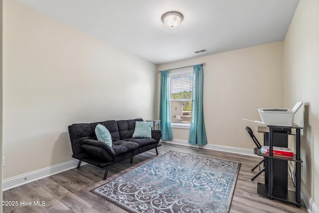 office area with visible vents, baseboards, and wood finished floors