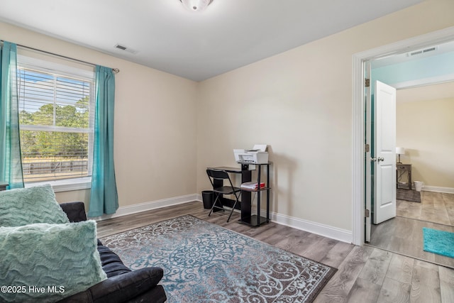 office featuring visible vents, baseboards, and wood finished floors