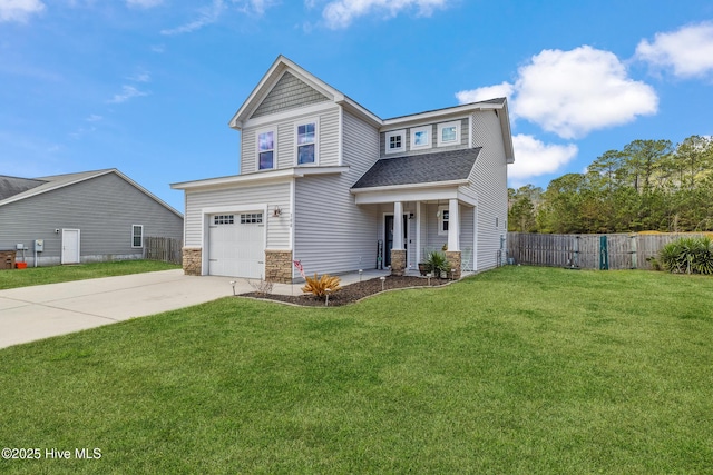 view of front facade with an attached garage, fence, driveway, stone siding, and a front yard