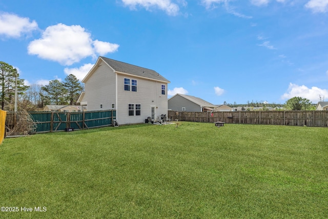 back of property featuring a fenced backyard and a yard