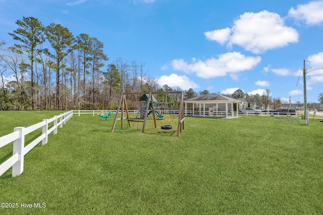 communal playground with a lawn and fence