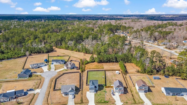 birds eye view of property with a view of trees