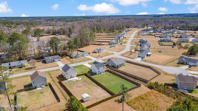 birds eye view of property with a view of trees