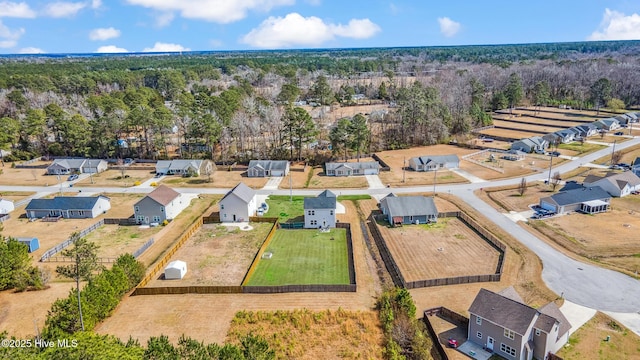 birds eye view of property with a wooded view