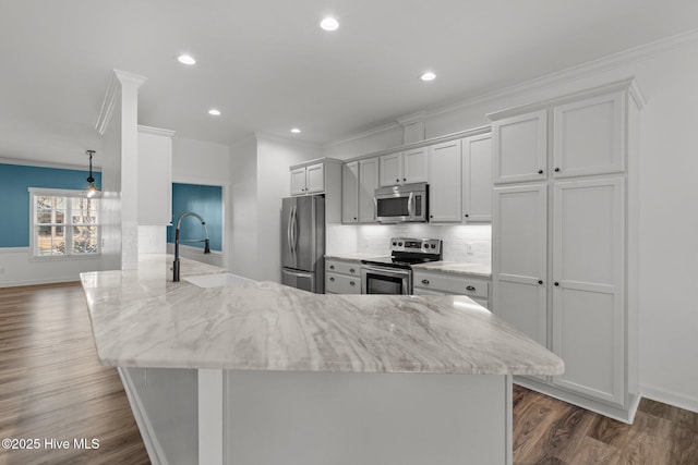 kitchen featuring dark wood-style flooring, crown molding, stainless steel appliances, tasteful backsplash, and a sink