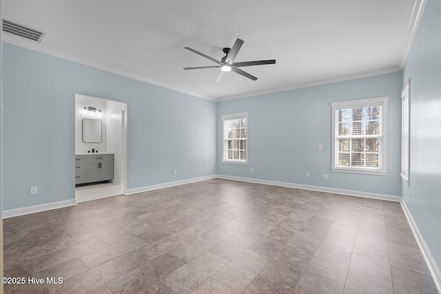 spare room featuring plenty of natural light, visible vents, baseboards, and ornamental molding