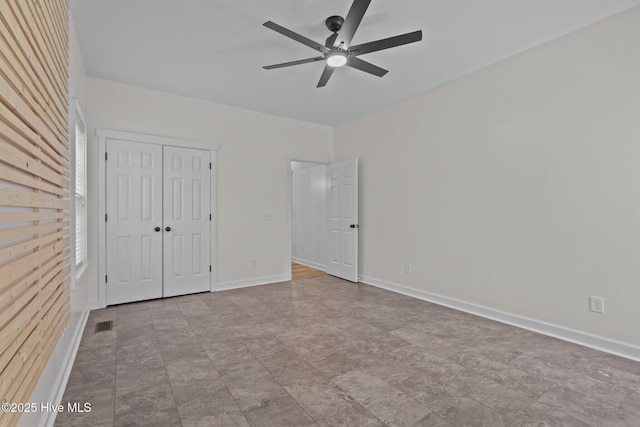 unfurnished bedroom with a ceiling fan, a closet, visible vents, and baseboards