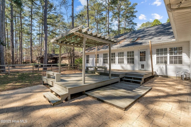 wooden deck featuring a patio, fence, and a pergola