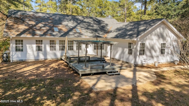 back of property with crawl space, roof with shingles, a deck, and a pergola