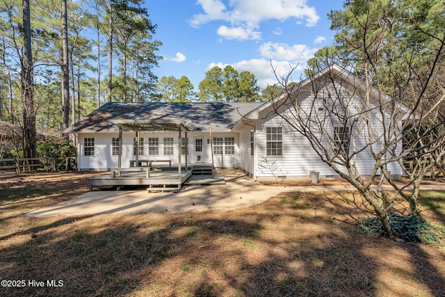 rear view of house featuring crawl space and a wooden deck