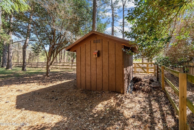 view of shed featuring fence