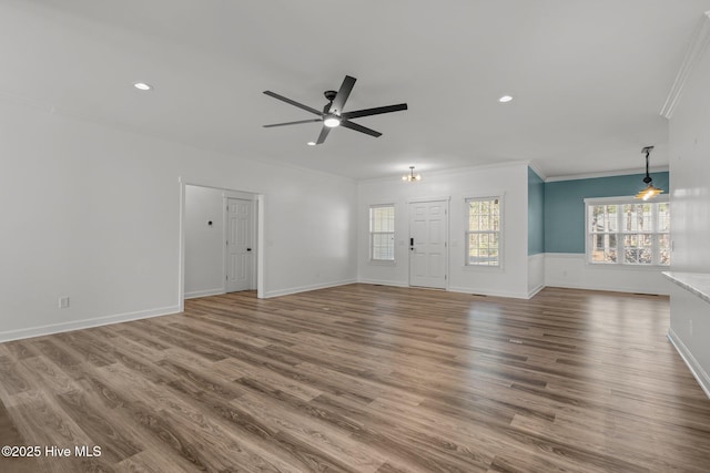 unfurnished living room with recessed lighting, a ceiling fan, crown molding, and wood finished floors