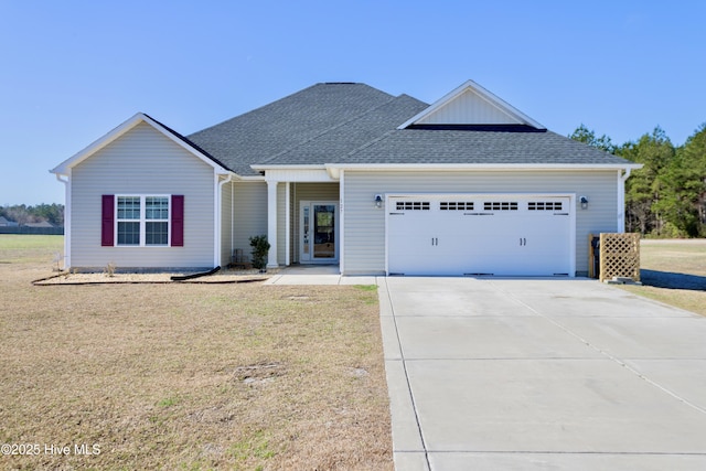 view of front of property featuring a garage, concrete driveway, roof with shingles, and a front lawn