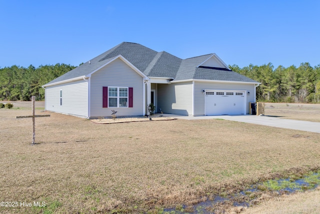 ranch-style home featuring a garage, driveway, a shingled roof, and a front yard