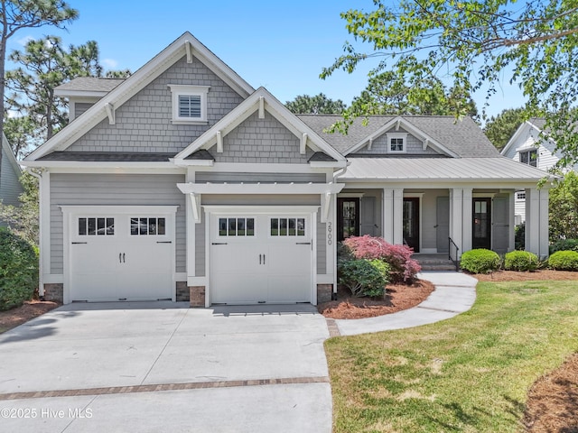 2900 Legends Dr, Southport, NC 28461 - craftsman house with driveway, a front lawn, covered porch, a shingled roof, and a garage