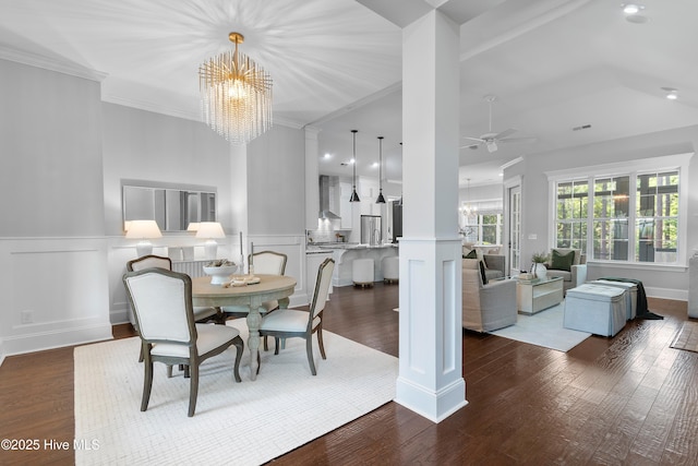 2900 Legends Dr, Southport, NC 28461 - dining room with a chandelier, crown molding, a ceiling fan, a wainscoted wall, and dark wood-style flooring