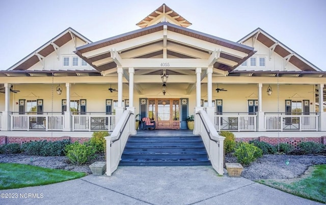 entrance to property with ceiling fan and a porch