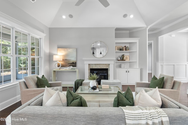 2900 Legends Dr, Southport, NC 28461 - living room with vaulted ceiling, ceiling fan, a fireplace, ornamental molding, and wood finished floors
