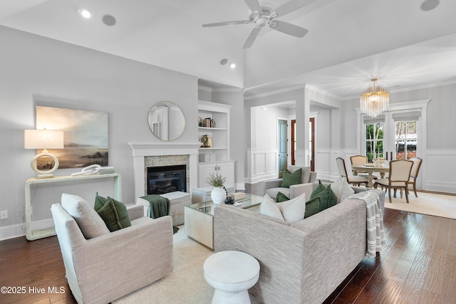 2900 Legends Dr, Southport, NC 28461 - living room with a ceiling fan, a chandelier, wood finished floors, a glass covered fireplace, and recessed lighting