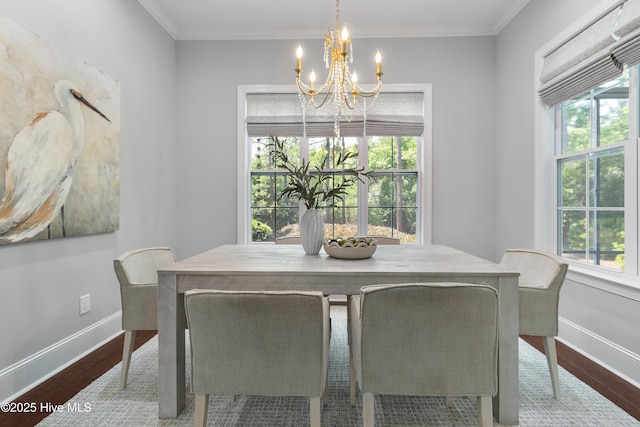 2900 Legends Dr, Southport, NC 28461 - dining space featuring a chandelier, wood finished floors, baseboards, and ornamental molding