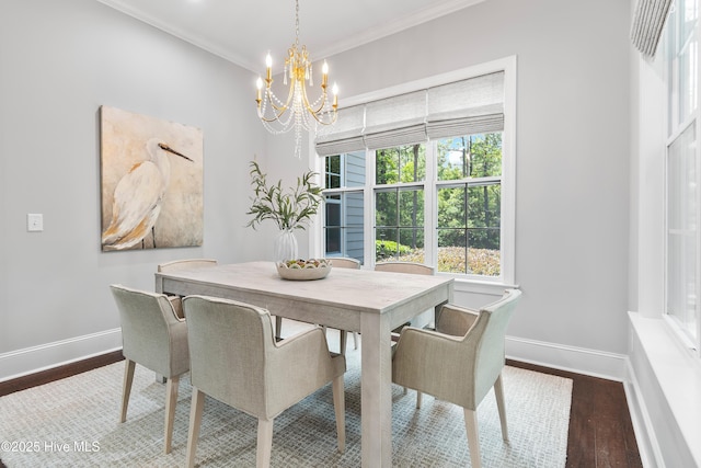 2900 Legends Dr, Southport, NC 28461 - dining space with a chandelier, baseboards, dark wood-style floors, and crown molding