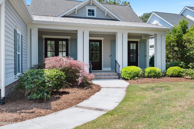 2900 Legends Dr, Southport, NC 28461 - property entrance with a shingled roof, covered porch, a standing seam roof, and metal roof