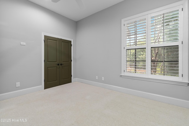 2900 Legends Dr, Southport, NC 28461 - empty room with plenty of natural light, carpet floors, a ceiling fan, and baseboards