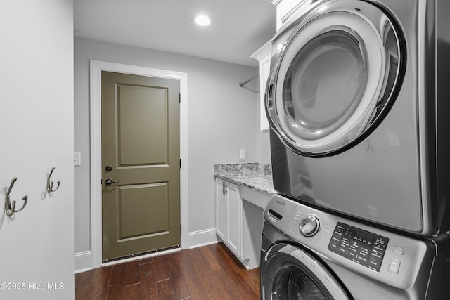 2900 Legends Dr, Southport, NC 28461 - laundry room featuring stacked washer and clothes dryer, cabinet space, dark wood-style flooring, recessed lighting, and baseboards