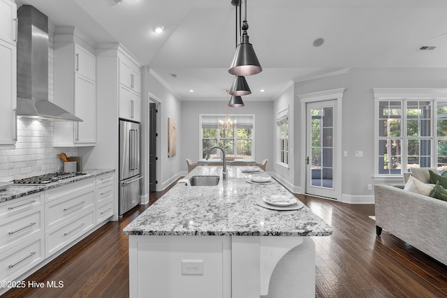 2900 Legends Dr, Southport, NC 28461 - kitchen featuring a sink, wall chimney range hood, appliances with stainless steel finishes, dark wood finished floors, and decorative backsplash