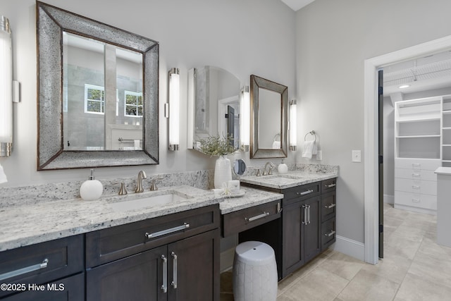 2900 Legends Dr, Southport, NC 28461 - full bathroom with vanity, a spacious closet, and tile patterned flooring