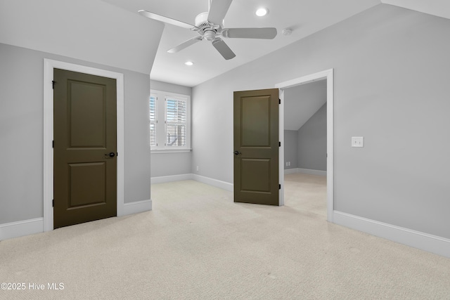 2900 Legends Dr, Southport, NC 28461 - unfurnished bedroom with vaulted ceiling, light carpet, recessed lighting, baseboards, and a ceiling fan