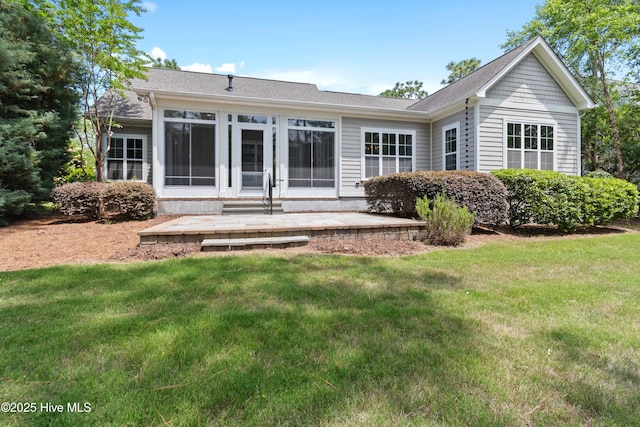 2900 Legends Dr, Southport, NC 28461 - rear view of property featuring a yard, a patio area, and a shingled roof