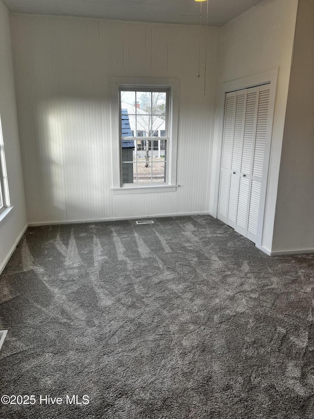 unfurnished bedroom with carpet floors and a closet