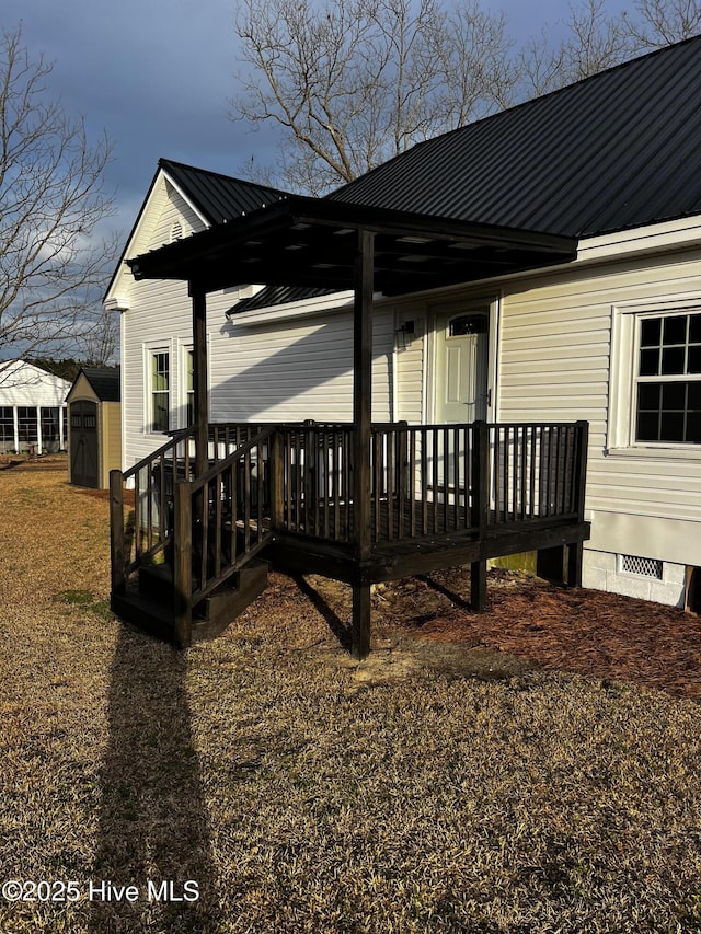 exterior space featuring metal roof, a shed, crawl space, and an outdoor structure