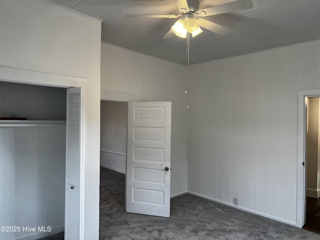 unfurnished bedroom with a closet, carpet flooring, and a ceiling fan