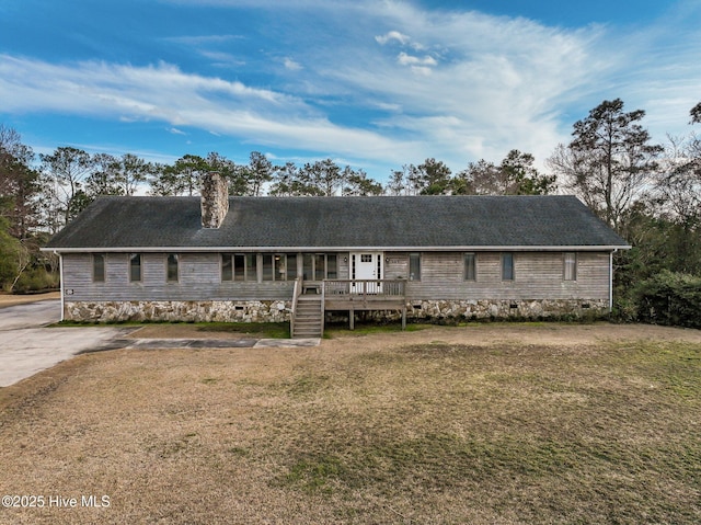 single story home with concrete driveway, a front yard, a chimney, a deck, and crawl space