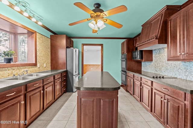 kitchen featuring dark countertops, light tile patterned floors, black appliances, and a sink