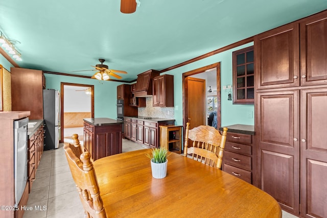 dining space with light tile patterned floors, a ceiling fan, and crown molding