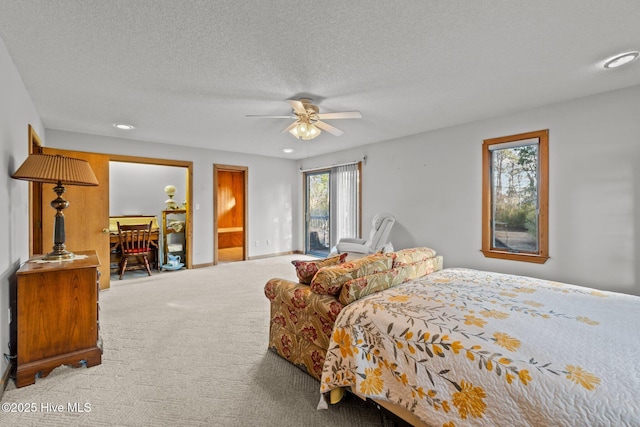 bedroom featuring ceiling fan, carpet floors, and a textured ceiling