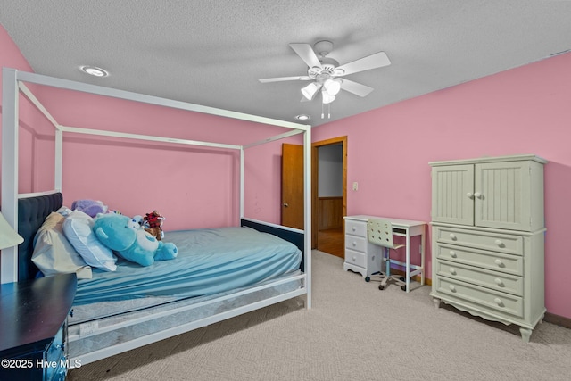 bedroom featuring light carpet and a textured ceiling