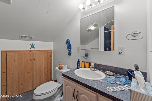 bathroom with visible vents, toilet, vanity, and lofted ceiling