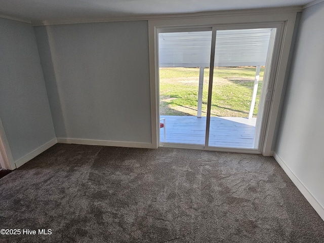 unfurnished room with baseboards and dark carpet