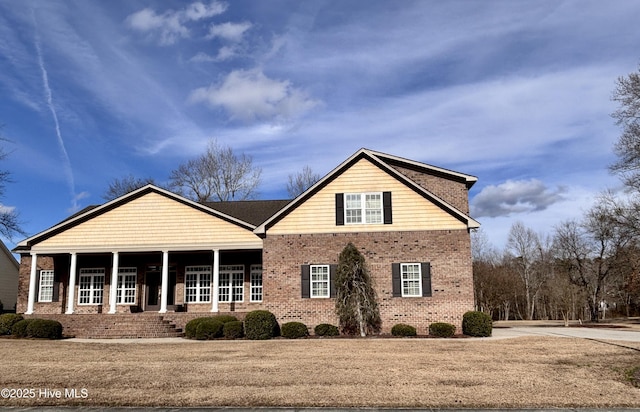 view of front of property featuring covered porch and brick siding