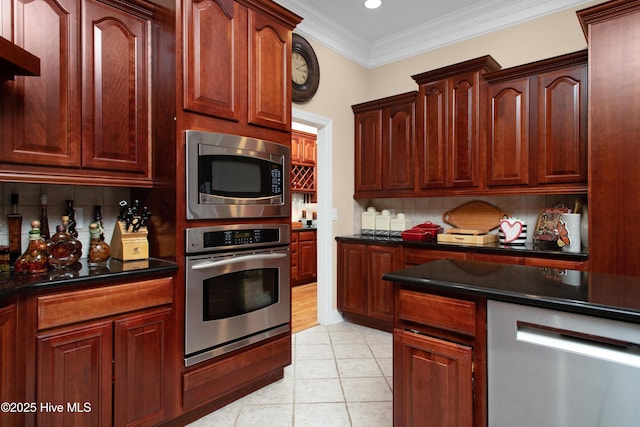 906 Taberna Cir, New Bern, NC 28562 - kitchen with dark countertops, appliances with stainless steel finishes, ornamental molding, and light tile patterned flooring