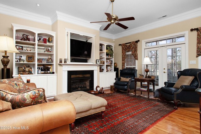 906 Taberna Cir, New Bern, NC 28562 - living area with visible vents, ornamental molding, french doors, a fireplace, and wood finished floors