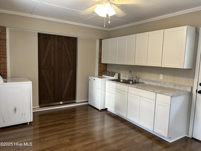 laundry area featuring laundry area, a sink, a ceiling fan, dark wood finished floors, and crown molding