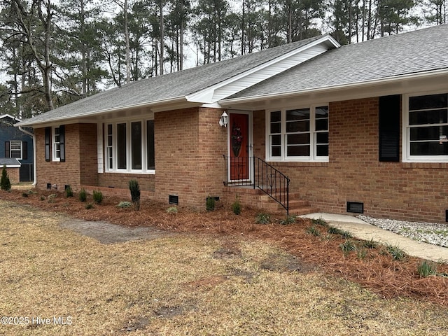 ranch-style house with a shingled roof, crawl space, and brick siding