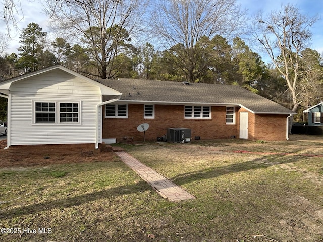 rear view of house featuring crawl space, central AC, a yard, and brick siding