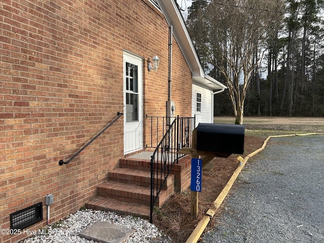 property entrance with brick siding