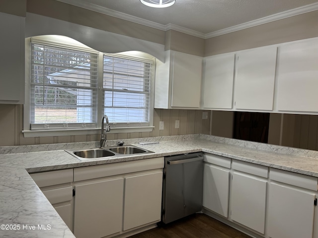 kitchen featuring crown molding, light countertops, stainless steel dishwasher, white cabinets, and a sink